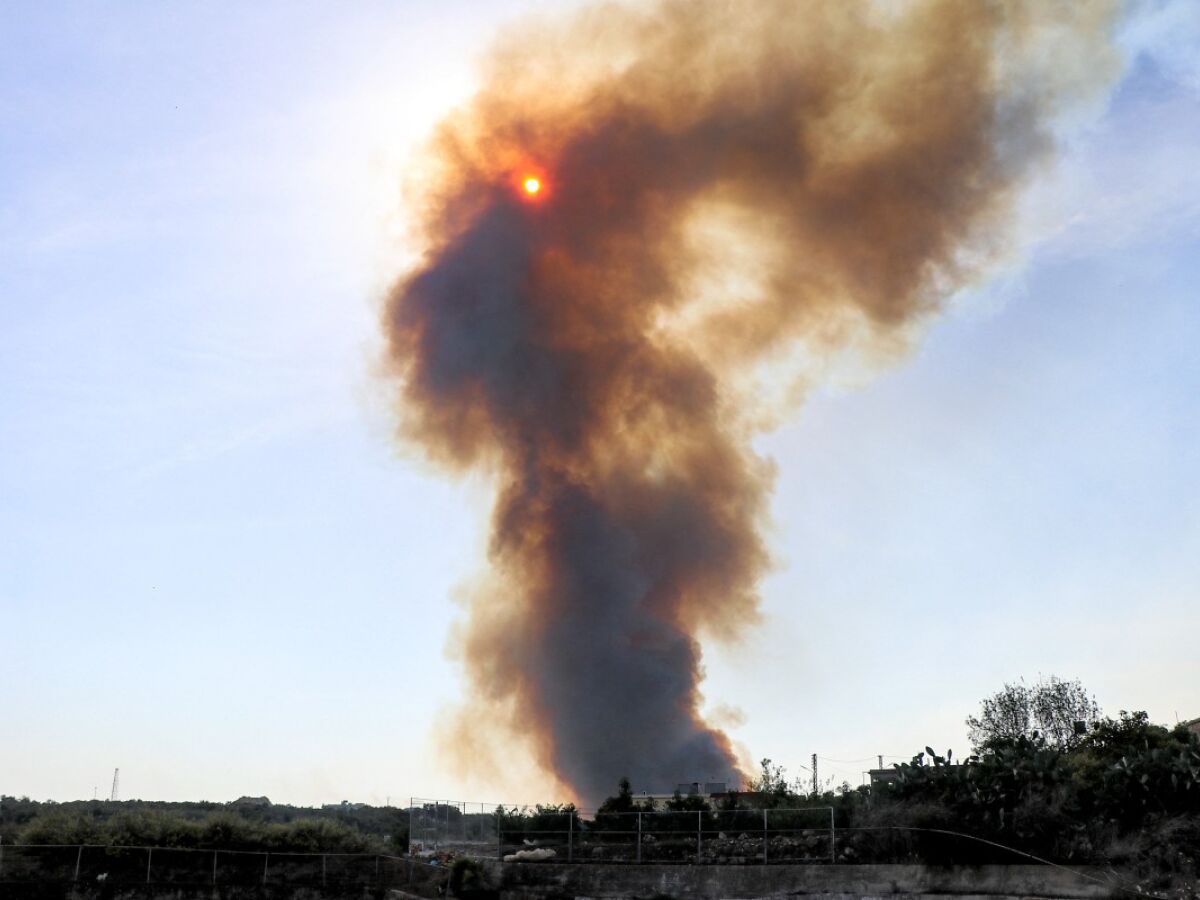 Nuvem de fumaça cobre o sol durante um incêndio florestal que começou após bombardeios israelenses no sul do Líbano, perto da fronteira com o norte de Israel