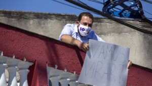 Com Covid, Boulos aparece na sacada de sua casa com cartaz 'Vamos virar'