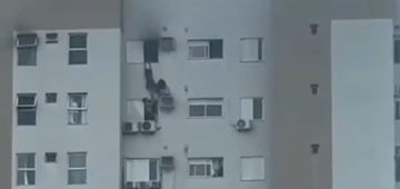 Mulher se pendura em ar-condicionado no 12&ordm; andar para salvar mãe e criança de incêndio