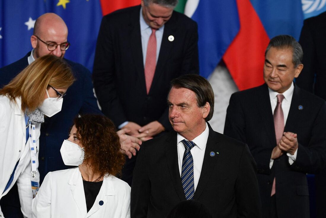 O presidente brasileiro Jair Bolsonaro (C) observa como os trabalhadores de saúde se juntam aos líderes mundiais para posar para uma foto em grupo na Cúpula de Líderes Mundiais do G20 em 30 de outubro de 2021 no centro de convenções "La Nuvola"