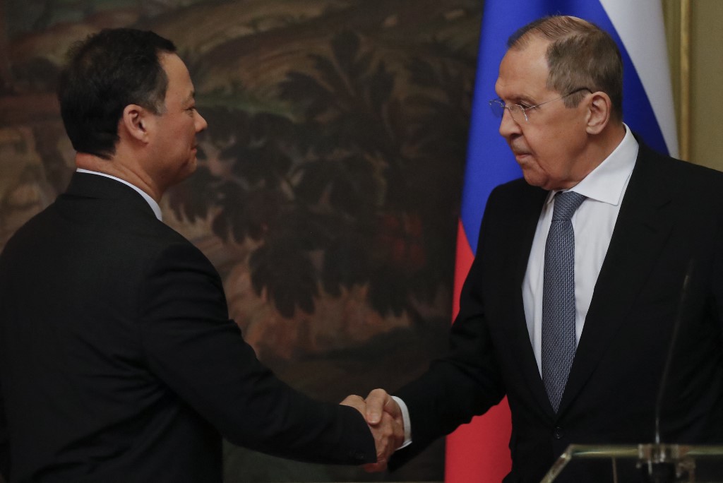 Russian Foreign Minister Sergei Lavrov (R) shakes hands with his Kyrgyz counterpart Ruslan Kazakbayev during a joint press conference following their talks in Moscow on March 5, 2022