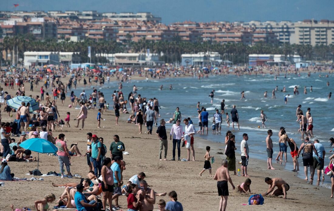 Pessoas tomam banho de sol na praia de Malavarrosa, em Valência, enquanto a Espanha se prepara para uma onda de calor.