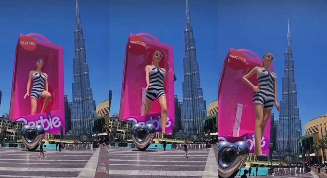 Enorme holograma da boneca Barbie, ao lado do Burj Khalifa, em Dubai, mais conhecido como o maior arranha-céu já construído pelo ser humano