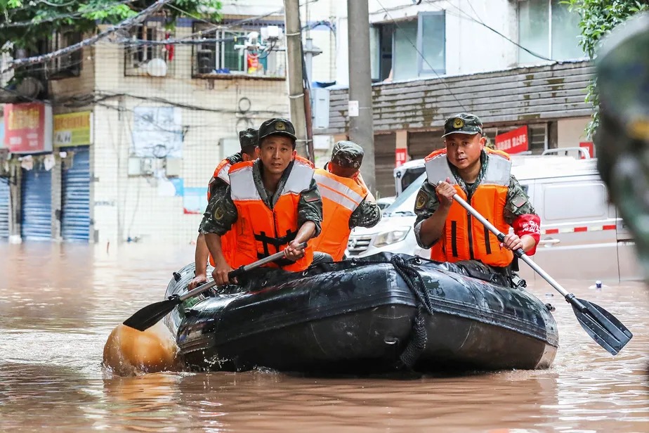 Policiais vasculham bairro inundado pelas chuvas em Chongqing, na China