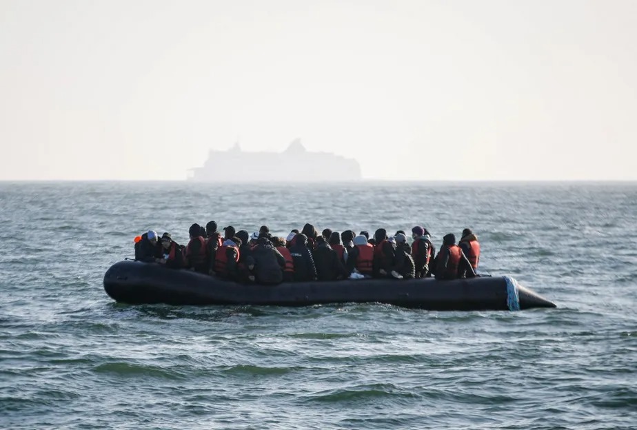 Migrantes esperando por ajuda do navio Abeille Languedoc depois que o gerador de seu barco quebrou em águas francesas, enquanto tentavam atravessar ilegalmente o Canal da Mancha 