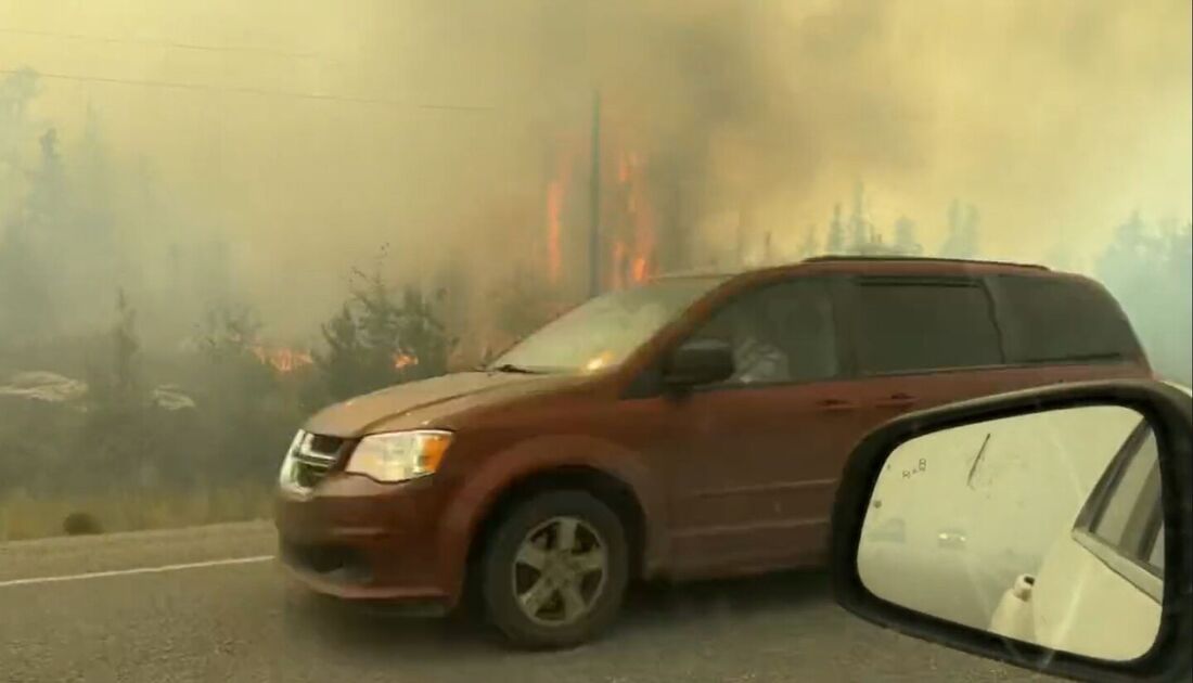 Veículos dirigindo na rodovia enquanto as pessoas evacuam de Yellowkife, Territórios do Noroeste, Canadá.