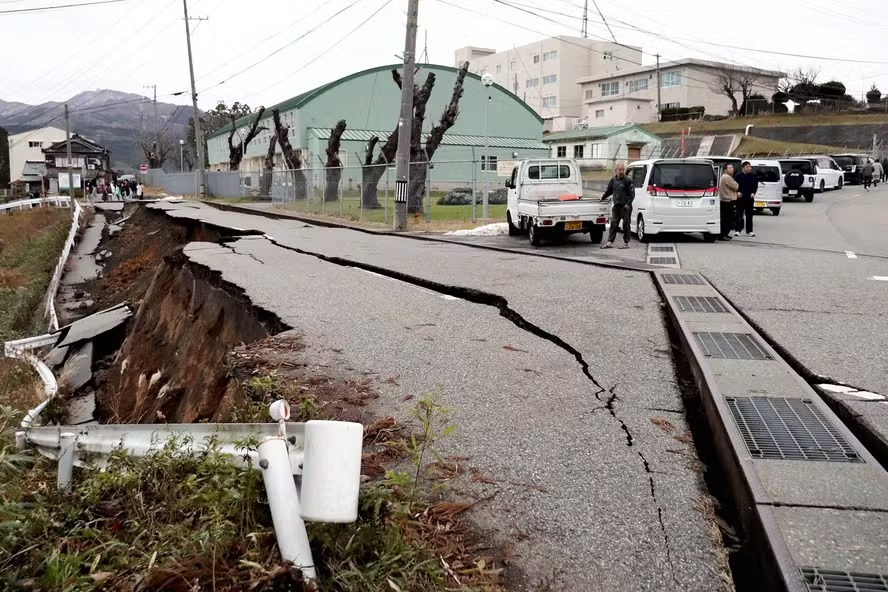 Pessoas observam rachaduras causadas por terremoto em Wajima 