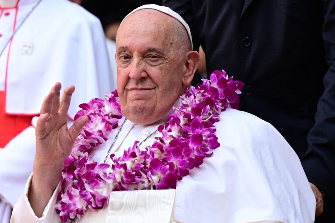 O Papa Francisco usa uma guirlanda de flores ao chegar para um encontro inter-religioso com jovens no Catholic Junior College em Cingapura, em 13 de setembro de 2024.