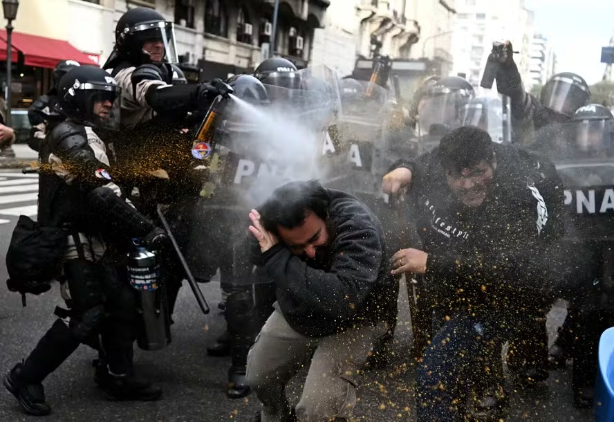 Polícia de choque usa spray de pimenta contra manifestantes durante um protesto em frente ao Congresso Nacional em Buenos Aires, em 11 de setembro de 2024 