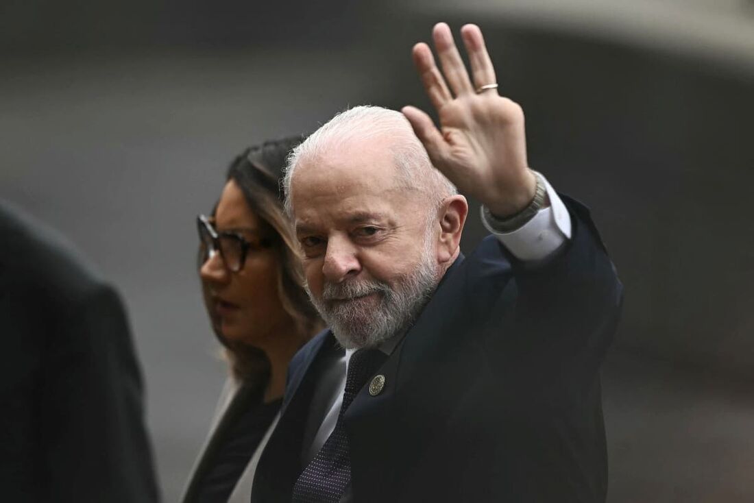 O presidente do Brasil, Luiz Inácio Lula da Silva (D), acena ao lado de sua esposa, Rosangela Lula da Silva, ao chegar à cerimônia de posse da presidente eleita do México, Claudia Sheinbaum