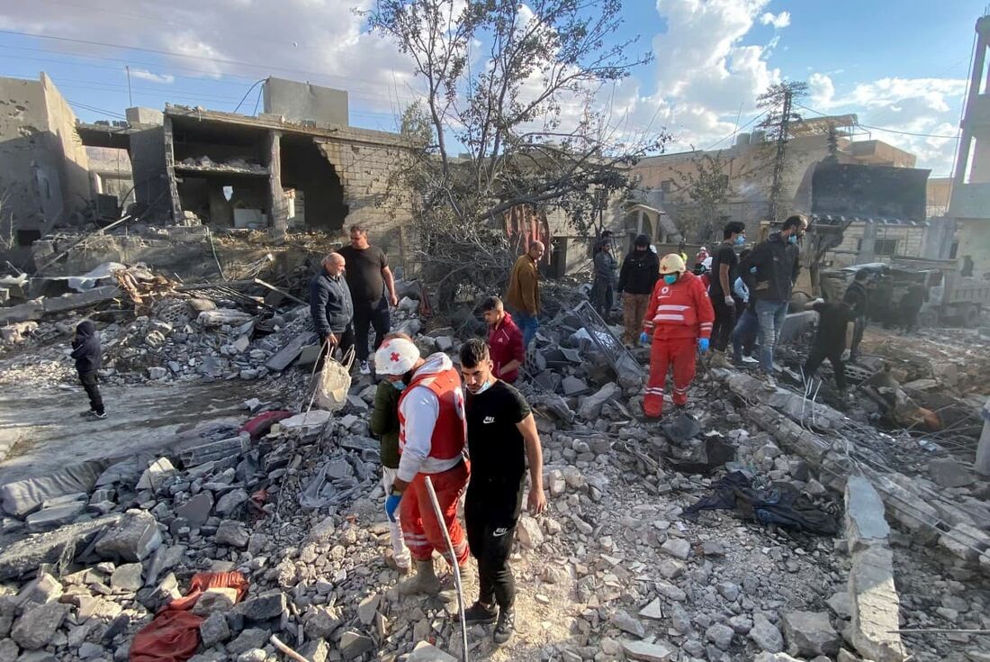 Pessoas inspecionam a destruição no local de um ataque aéreo israelense que teve como alvo a vila oriental de Bazzaliyeh, no distrito de Hermel, no vale de Bekaa, no Líbano