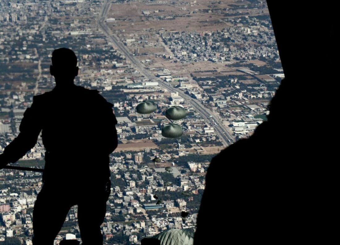 Membros do exército jordaniano realizando um lançamento aéreo de ajuda humanitária e de socorro ao sul da Faixa de Gaza