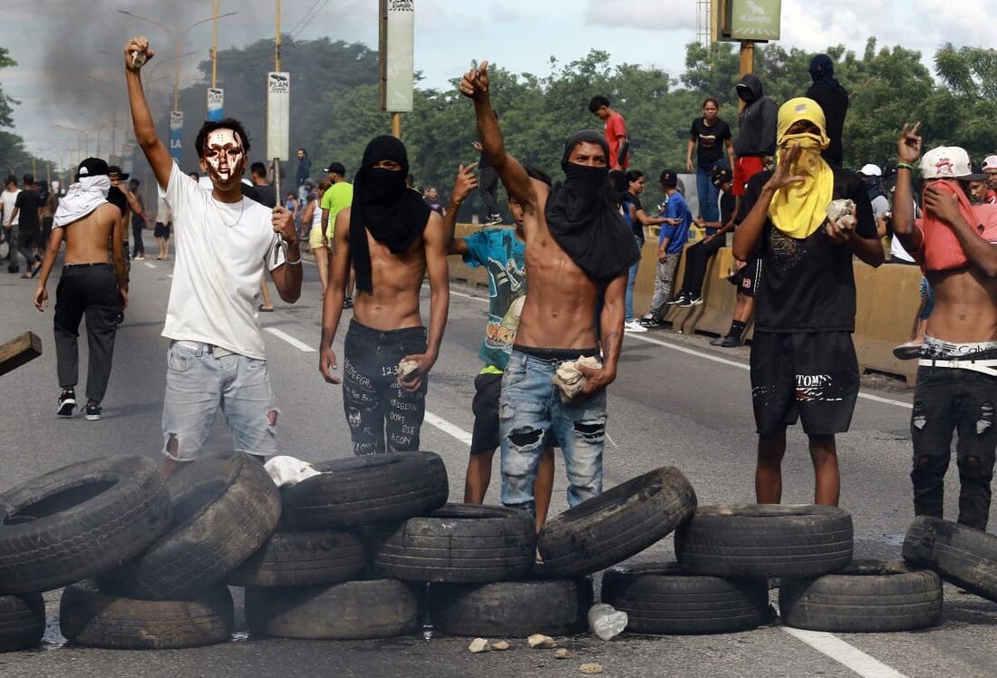 Manifestantes montam uma barricada durante um protesto contra o governo do presidente venezuelano Nicolás Maduro em Valência, estado de Carabobo, Venezuela