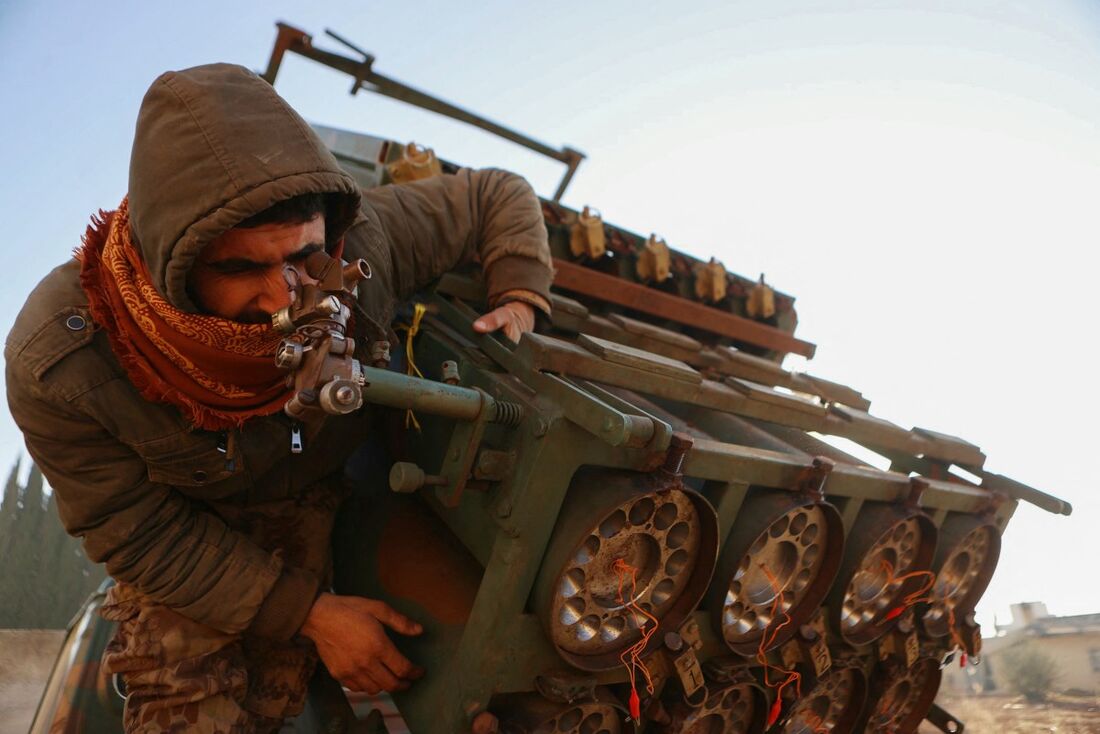 Um combatente inspeciona um lançador de foguetes do Exército Sírio apreendido no distrito de Khan al-Assal