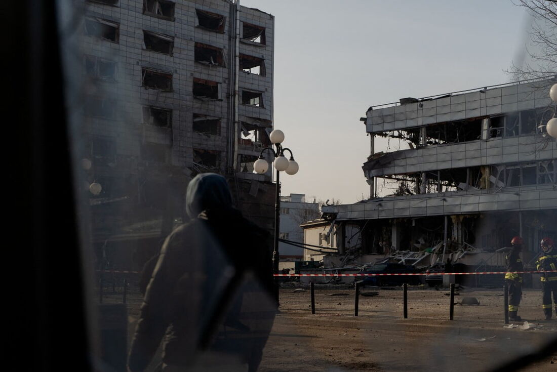 Conteúdo gráfico / Um homem passa por edifícios danificados após um ataque com mísseis em Kiev em meio à invasão russa da Ucrânia