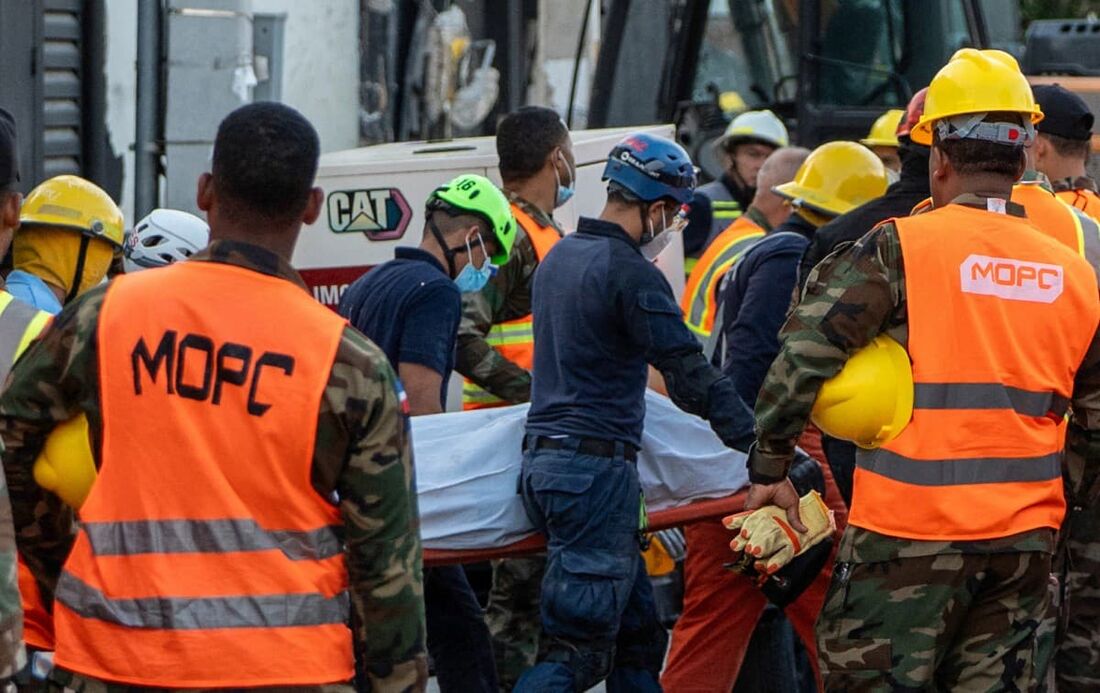 Equipes de resgate carregam o corpo de uma vítima na boate Jet Set um dia após o desabamento do teto em Santo Domingo