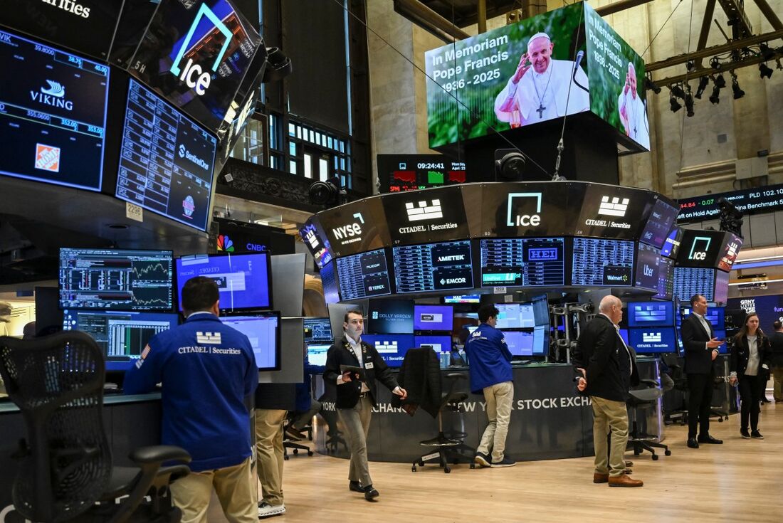 Operadores trabalham após um momento de silêncio em homenagem ao Papa Francisco, que faleceu na madrugada de 21 de abril, na abertura da Bolsa de Valores de Nova York (NYSE) 
