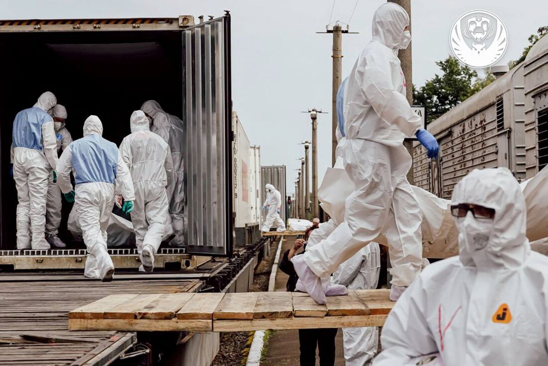 Funcionários do Comitê Internacional da Cruz Vermelha descarregam corpos de cidadãos ucranianos, incluindo militares, devolvidos pela Rússia 