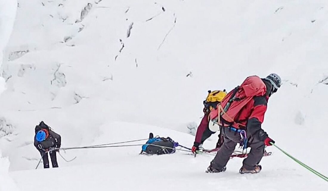 Socorristas carregando os restos mortais do montanhista japonês Chiaki Inada da montanha coberta de neve Huascaran em Huaraz