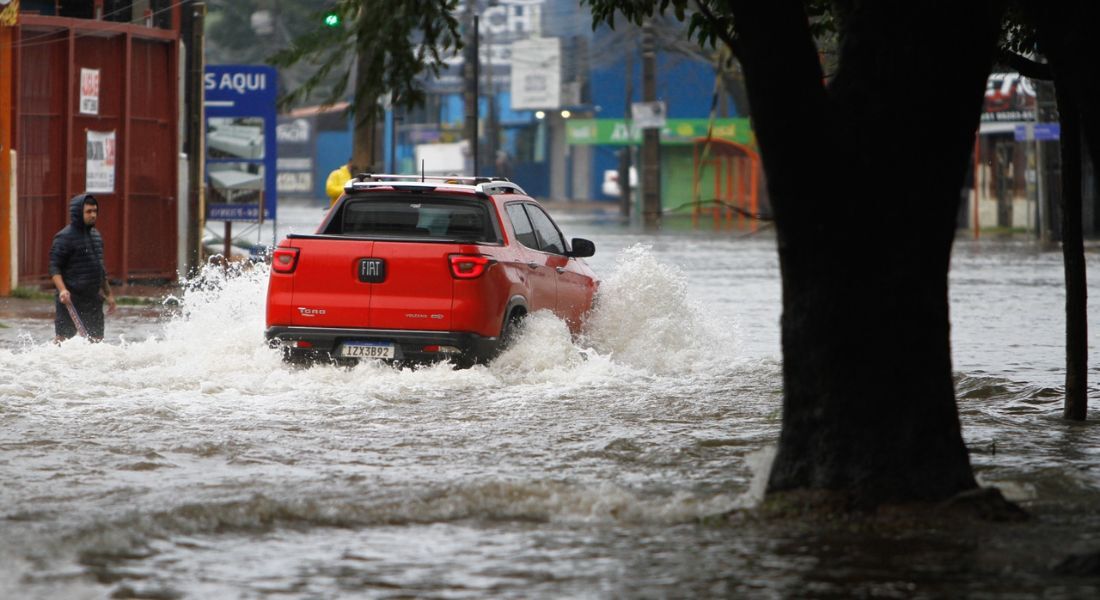 Moradores do bairro Mathias Velho, em Canoas, na região metropolitana de Porto Alegre (RS), enfrentam ruas alagadas após chuvas fortes nesta quarta-feira, 18 de junho de 2025.