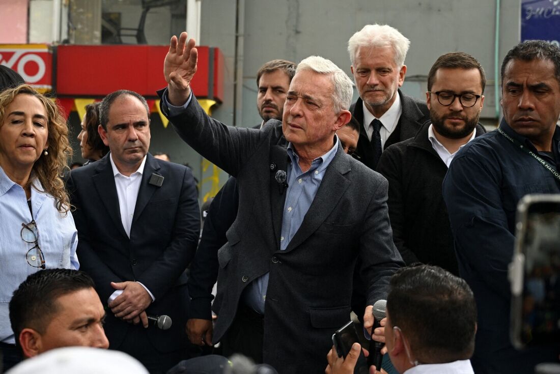 Presidente colombiano Álvaro Uribe Velez acena para apoiadores no local onde o candidato presidencial colombiano assassinado Miguel Uribe foi baleado durante campanha em 7 de junho, no bairro de Modelia, em Bogotá, em 23 de agosto de 2025