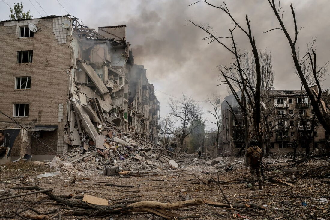 mum militar ucraniano entre os escombros no pátio de prédios residenciais destruídos na cidade de Kostyantynivka, na linha de frente, na região de Donetsk, em meio à invasão russa da Ucrânia. 