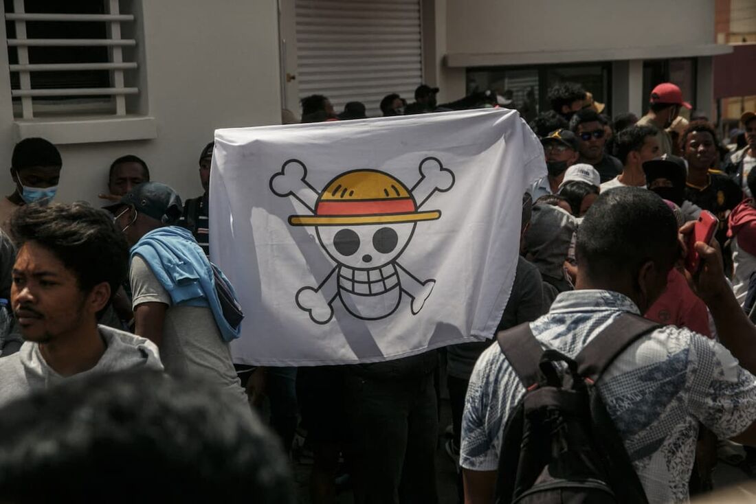 Um manifestante segura uma bandeira pirata do anime japonês One Piece durante uma manifestação contra os repetidos cortes de água e eletricidade em Antananarivo, em 30 de setembro de 2025.