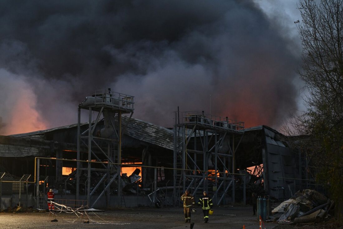 Bombeiros ucranianos apagam um incêndio em um depósito de alimentos após um ataque de míssil russo em Kiev