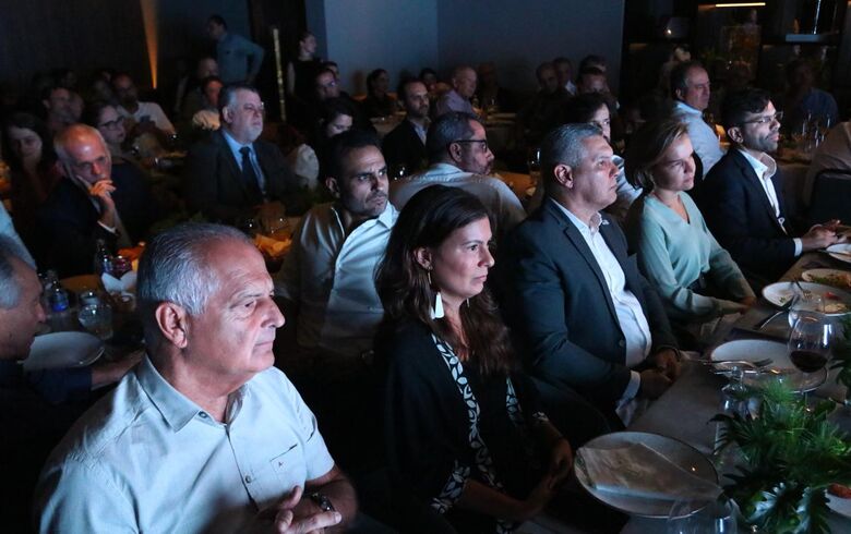 Convidados atentos ao anúncio da joint venture
